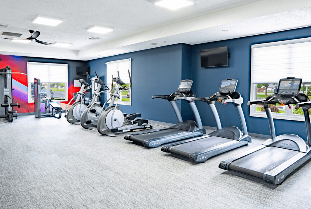 Gym with cardio machines and a television