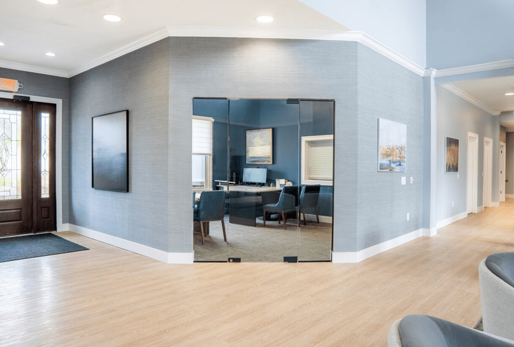 Conference room with blue walls and a large mirror
