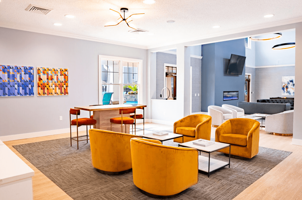 Living room with yellow chairs and a table with a laptop