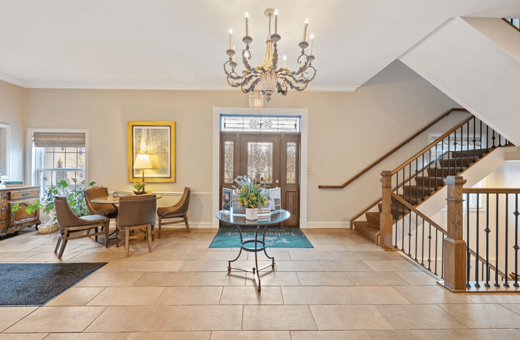 Spacious Clubhouse with a staircase and a chandelier at Indian Creek Apartments, 45236