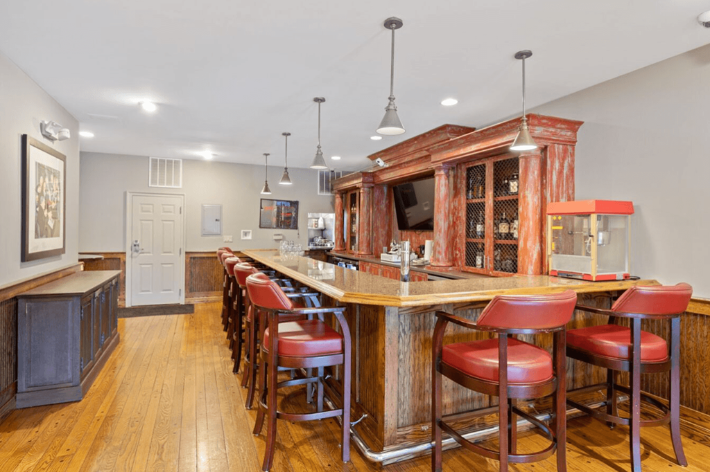 Large bar in a kitchen with red bar stools at Indian Creek Apartments, Cincinnati, OH