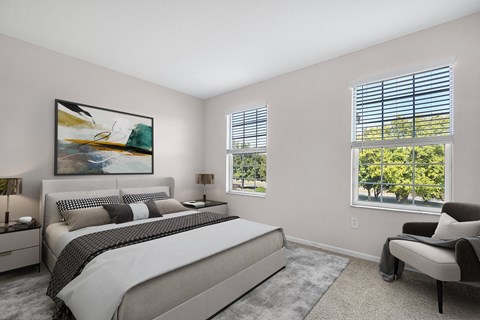 A bedroom with a large bed and a painting on the wall.