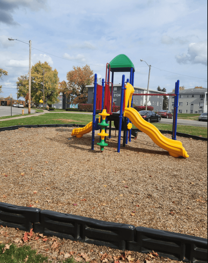 a playground in a park with a slide and other toys