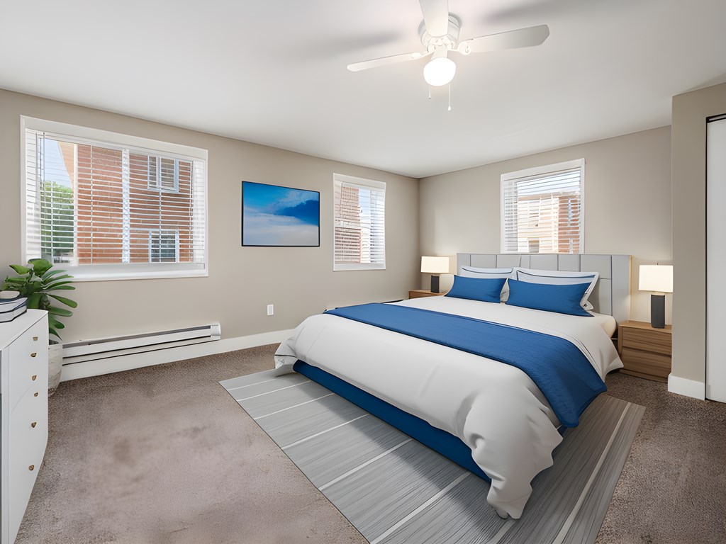 a bedroom with a bed and a ceiling fan