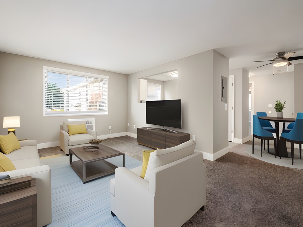 a living room with white furniture and a television
