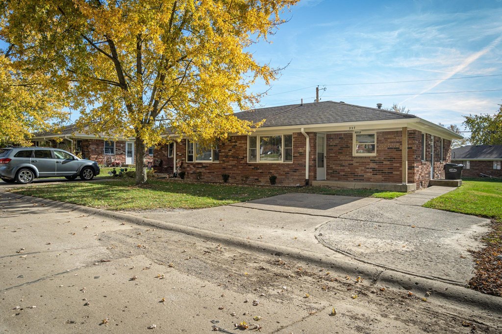 a small brick house with a car parked in the driveway at Stonebrook of Franklin, Franklin