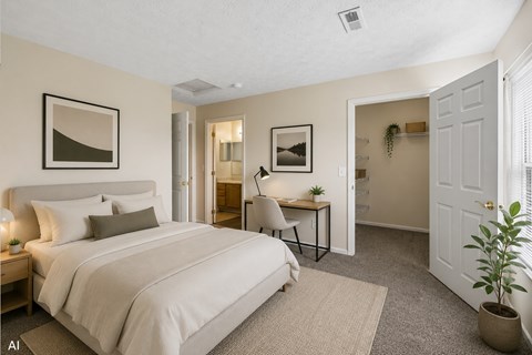 A bedroom with a large bed and a desk with a chair.