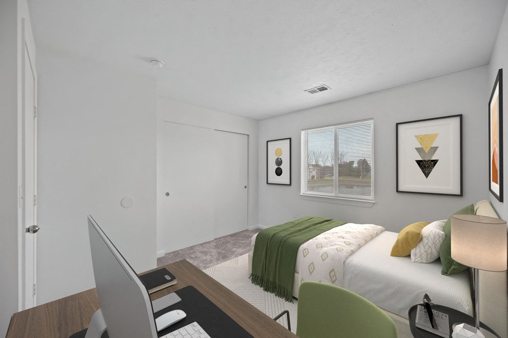 A bedroom with a bed, desk, and chair at Crystal Glen Apartments, Findlay, OH