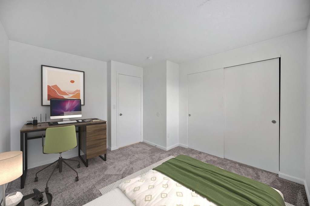 A bedroom with a bed, desk, and chair at Crystal Glen Apartments, Findlay, OH, 45840