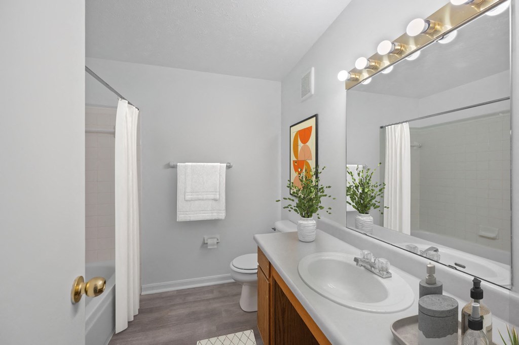 A bathroom with a white sink and a mirror above it at Crystal Glen Apartments, Findlay, Ohio