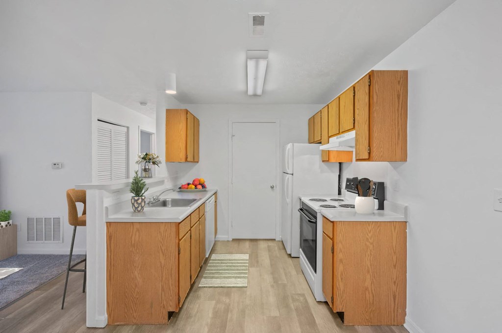 A kitchen with wooden cabinets and white appliances at Crystal Glen Apartments, Ohio, 45840