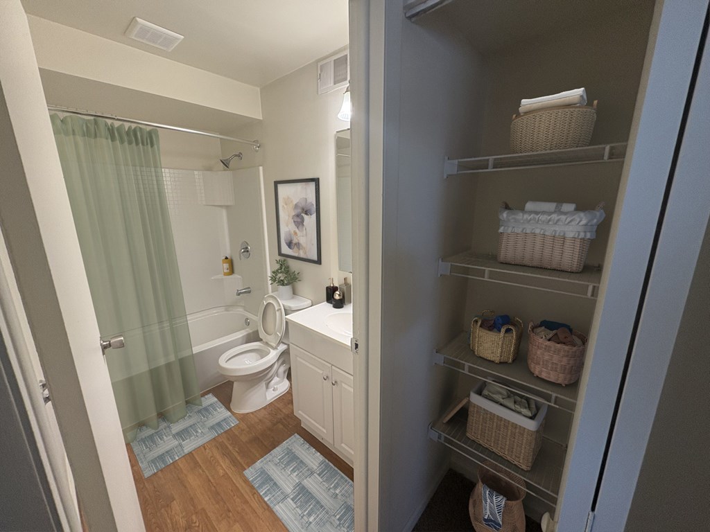 A bathroom with a toilet, sink, and shower.