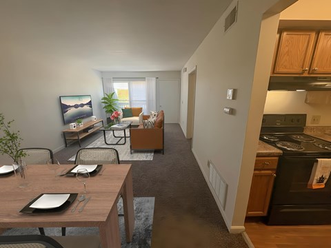 A modern kitchen with a dining table set for two.