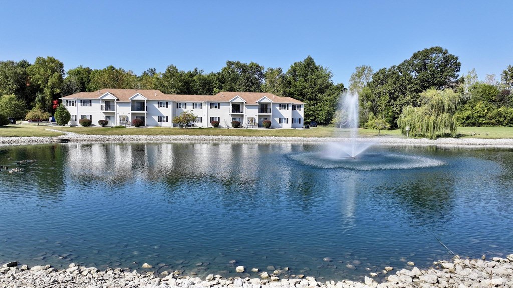 A building with a fountain in front of it.