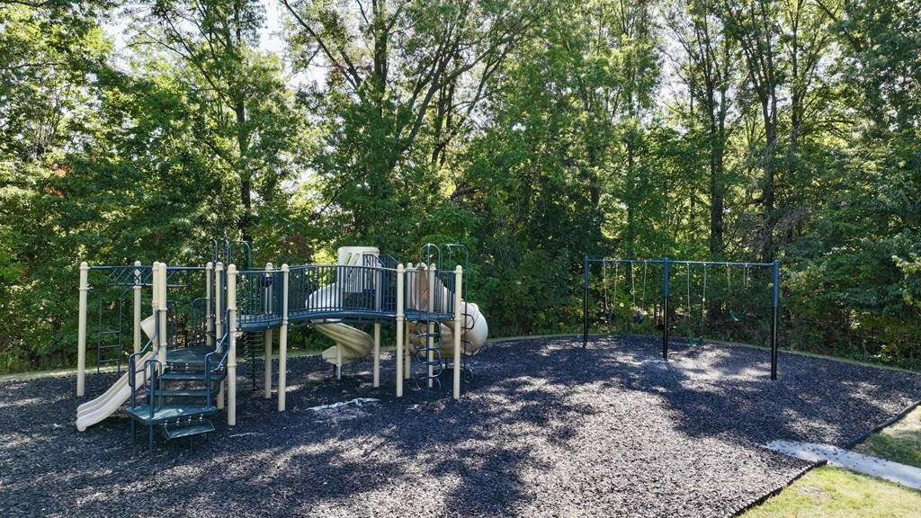 A playground with a slide, swings, and a climbing frame.