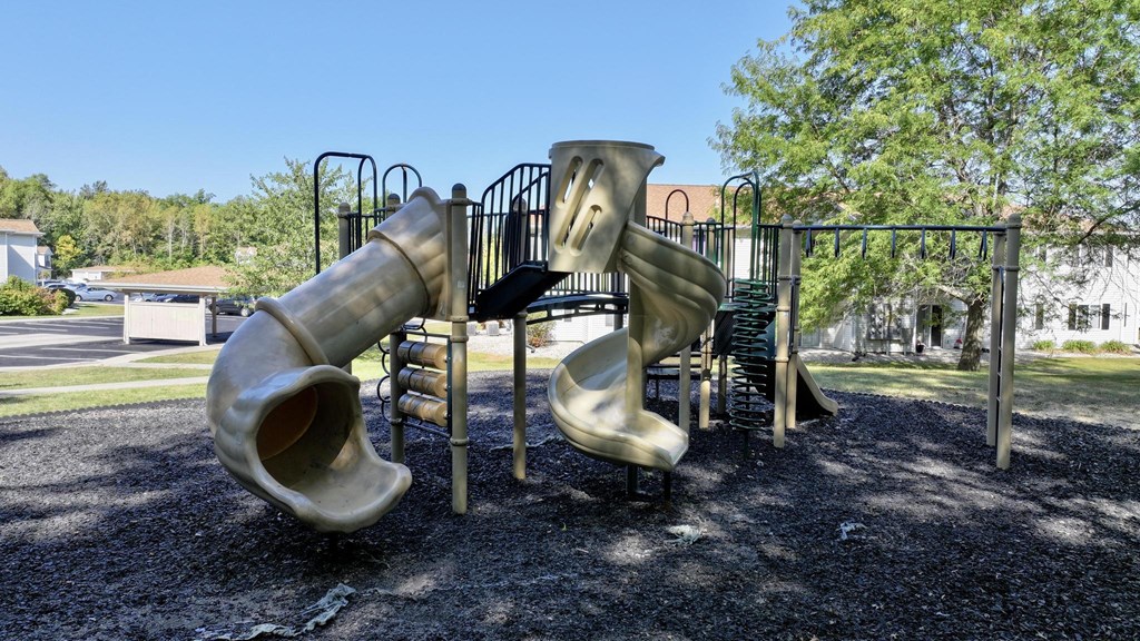 A playground with a slide and a climbing structure.