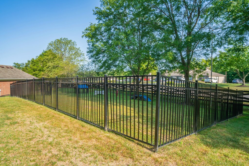 a wrought iron fence in front of a yard with a playground at Traditions at Slate Ridge, Reynoldsburg Ohio