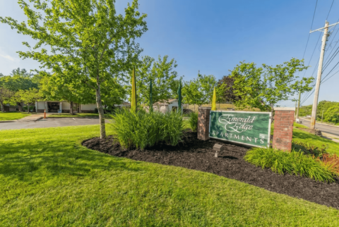 A sign for Emerald Edge Apartments is displayed in a landscaped area.