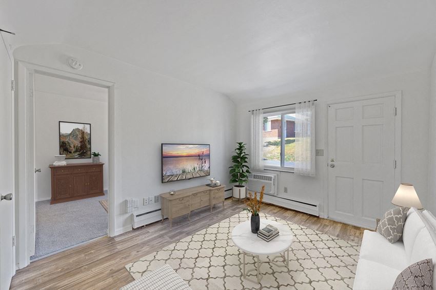 a living room with white walls and a white couch