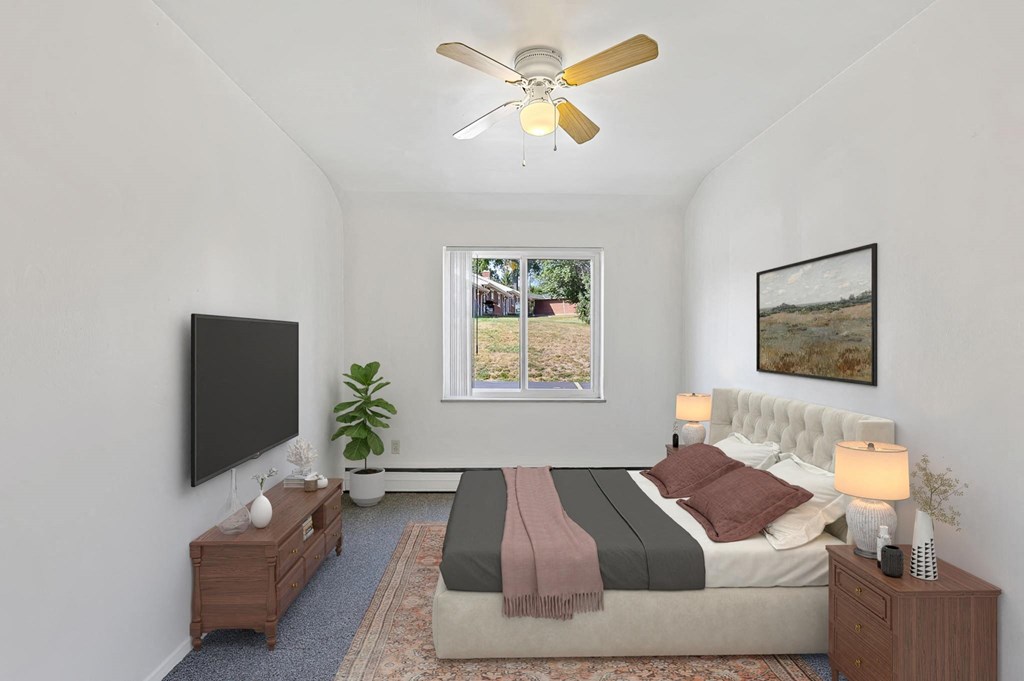 a bedroom with a bed and a ceiling fan