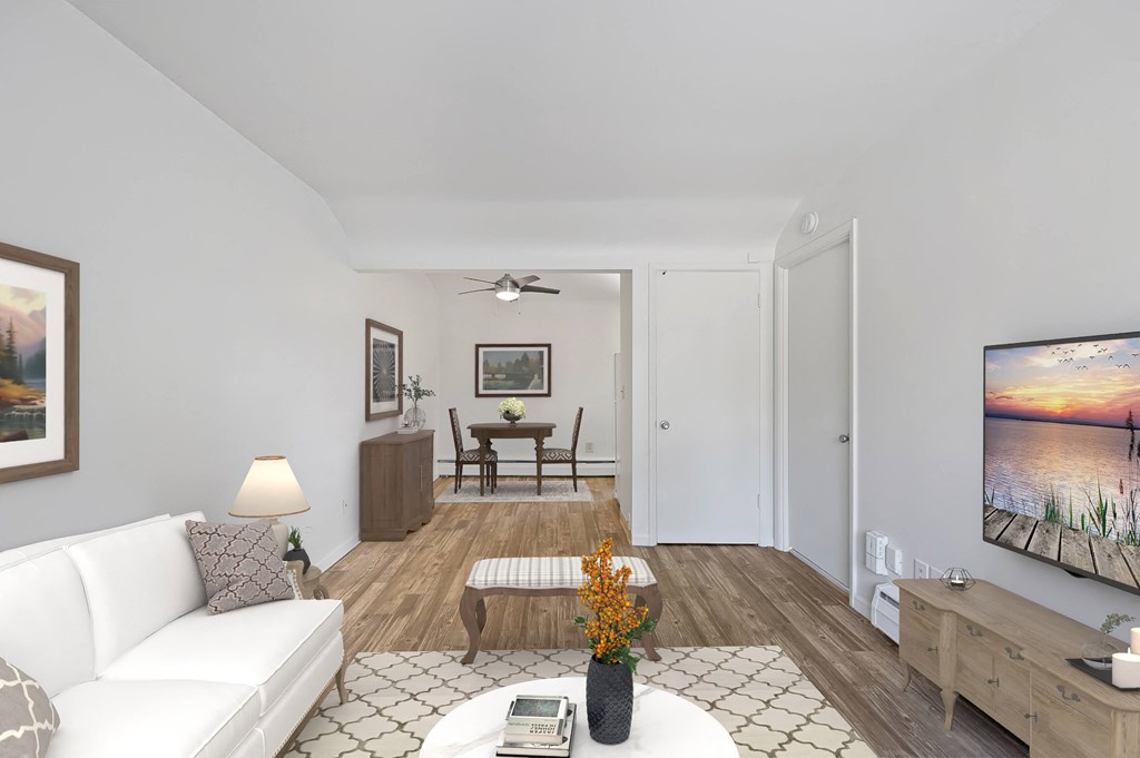 a living room with a white couch and a tv