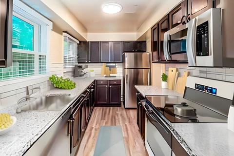 a kitchen with stainless steel appliances and marble counter tops