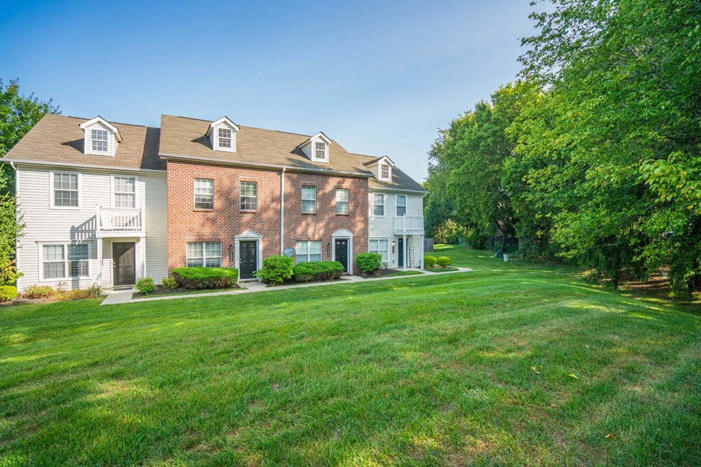 a large lawn in front of a brick house at Traditions at Slate Ridge, Ohio