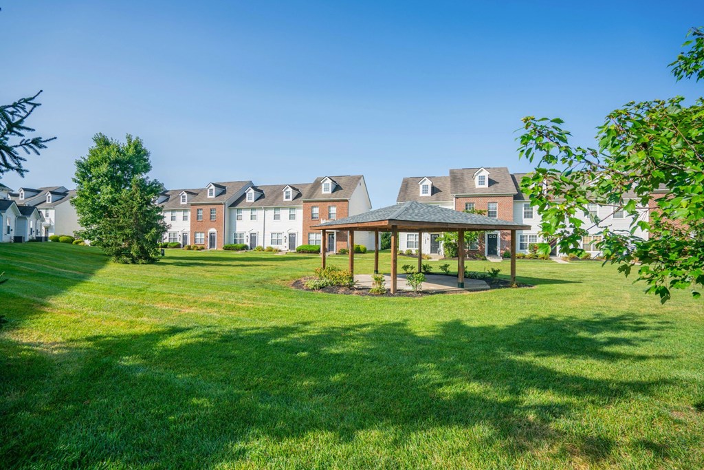 a park with a gazebo and houses in the background at Traditions at Slate Ridge, Reynoldsburg