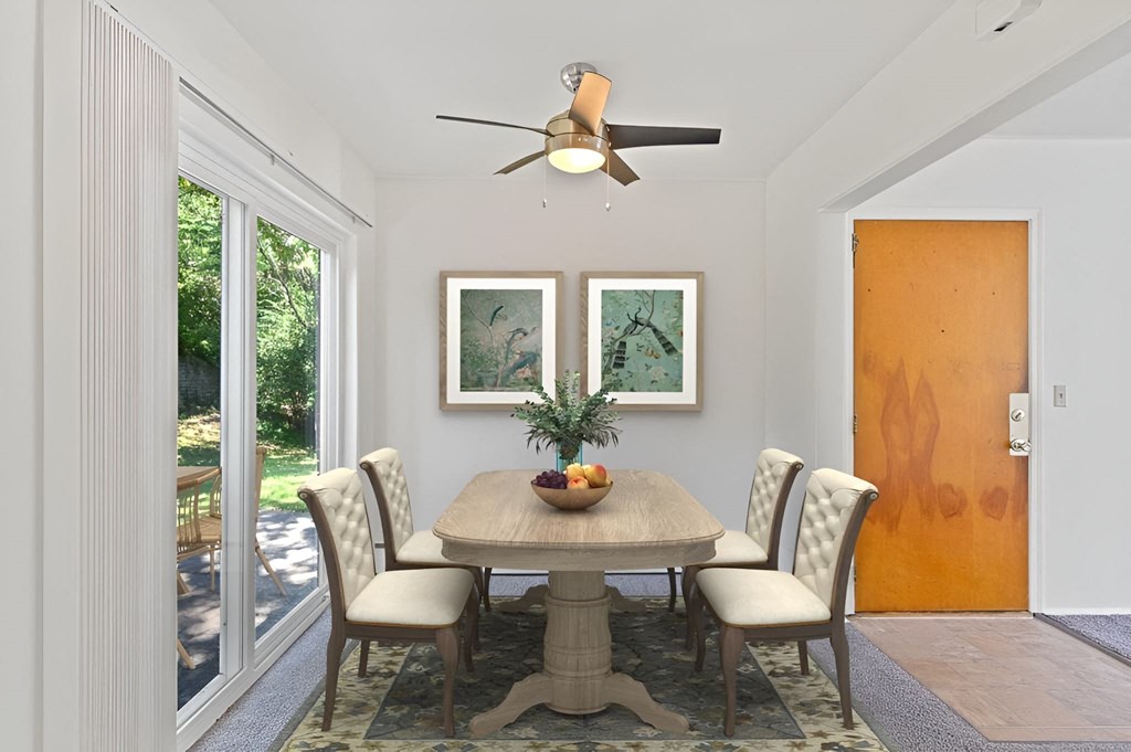 a dining room with a table and chairs and a ceiling fan