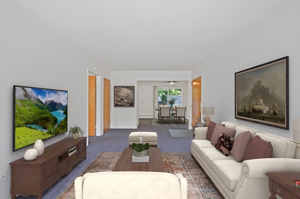 a living room with a white couch and a television