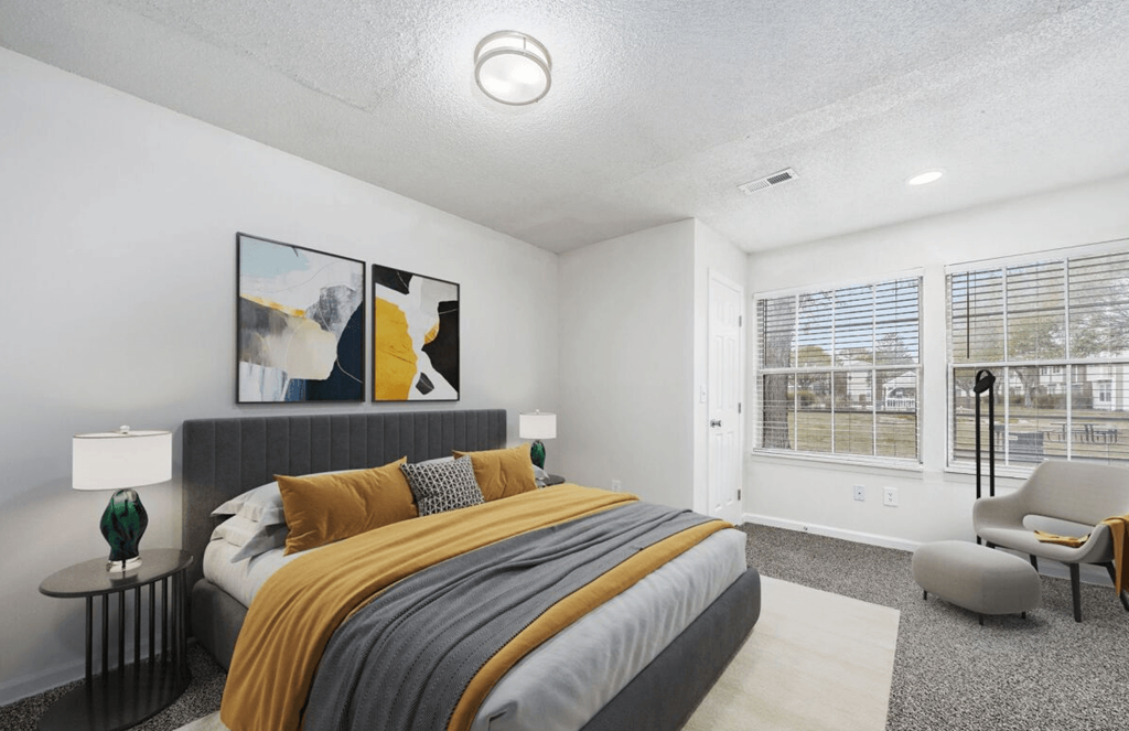 a bedroom with a bed and two windows at The Berryessa Apartments, Ohio, 98104
