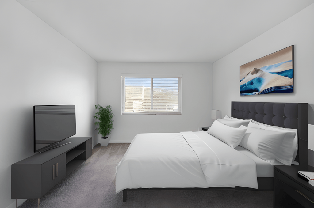 a bedroom with a white bed and a tv