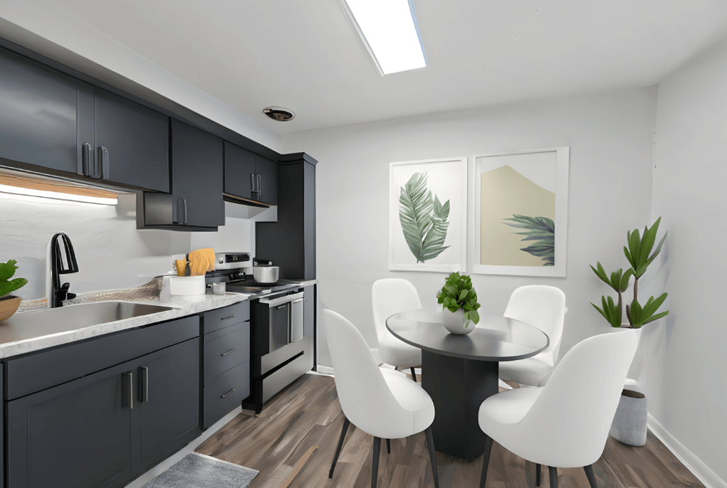 a kitchen with black cabinets and a table and chairs