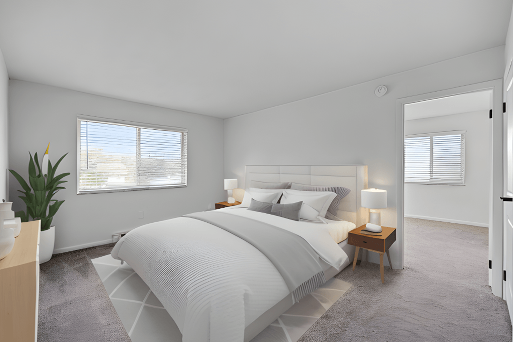 a white bedroom with a bed and a window