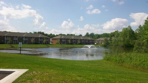 Pond with fountain and apartment buildings at Forest Ridge Apartments, Indianapolis