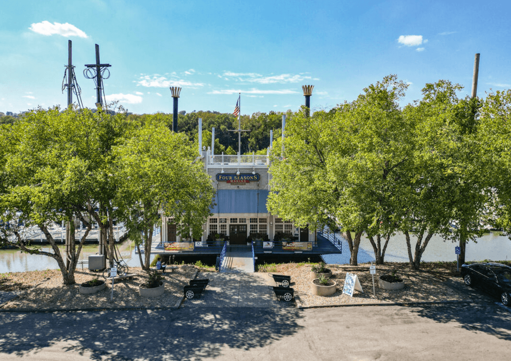 a view of a boat dock with trees in front of it