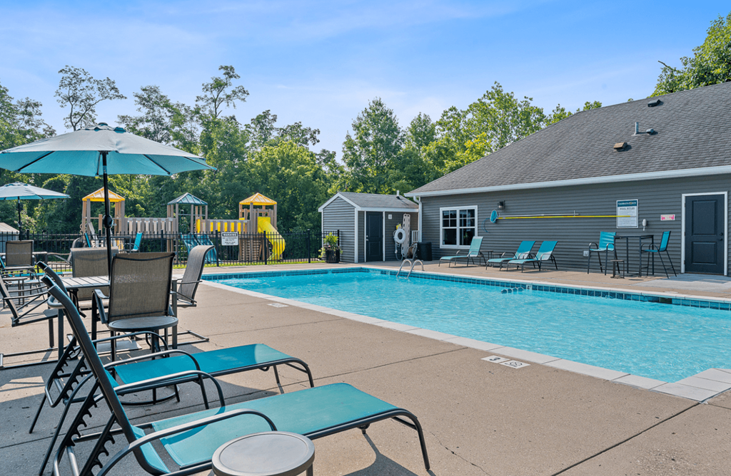 Resort style swimming pool is next to our house with chairs and an umbrella at Galbraith Pointe Apartments and Townhomes*, Ohio