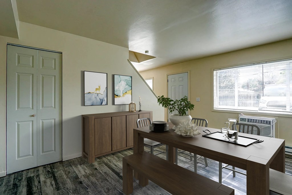 a dining room with a wooden table and chairs