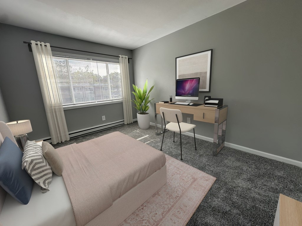 a bedroom with a bed and a desk with a computer