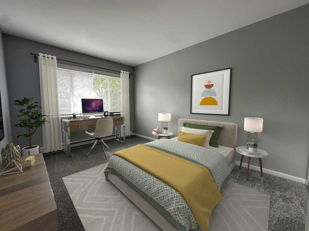 a bedroom with a bed and a desk with a computer