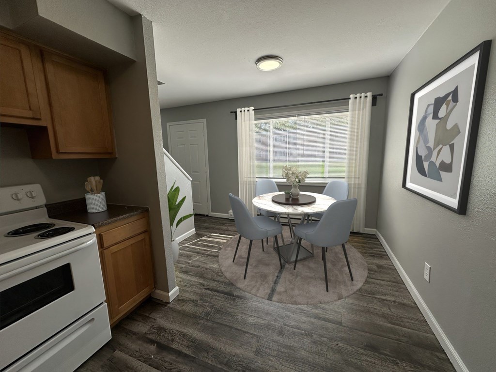 a kitchen and dining room with a table and chairs