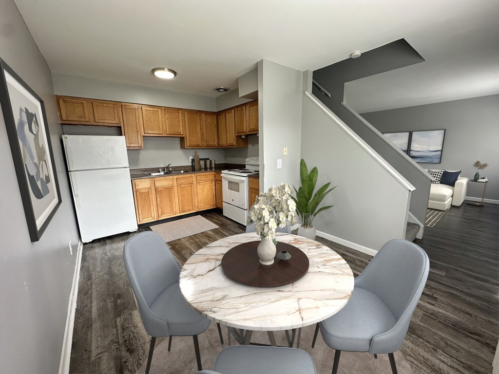 a kitchen and dining room with a table and chairs