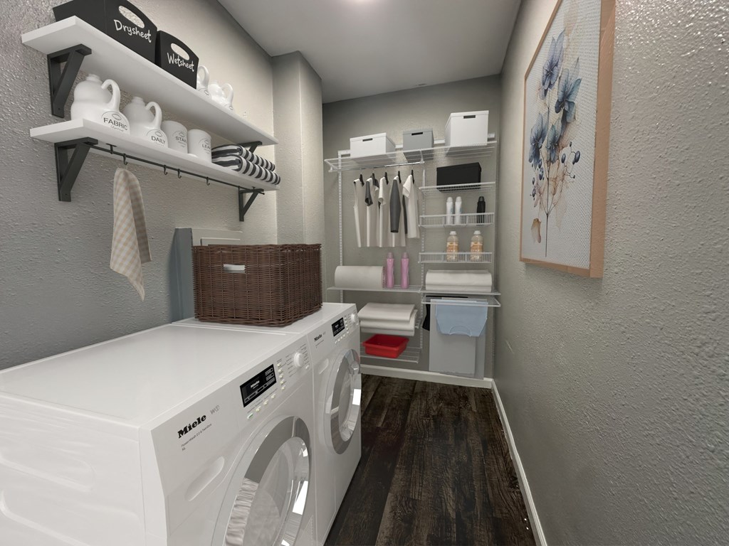 a laundry room with a washer and dryer and shelving and a closet