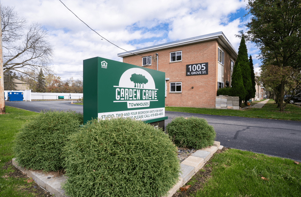 the sign for church hope apartments in front of a brick building