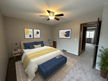 a bedroom with a bed and a ceiling fan - Photo Gallery 13
