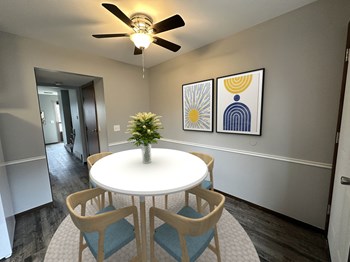 a dining area with a table and chairs and a ceiling fan - Photo Gallery 9