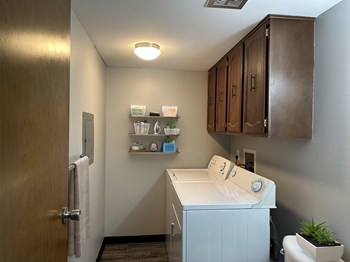 a laundry room with a washer and dryer - Photo Gallery 7