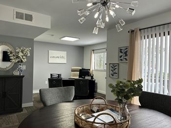 a dining area with a round table and a chandelier above it  at Timber Glen Apartments, Batavia, Ohio