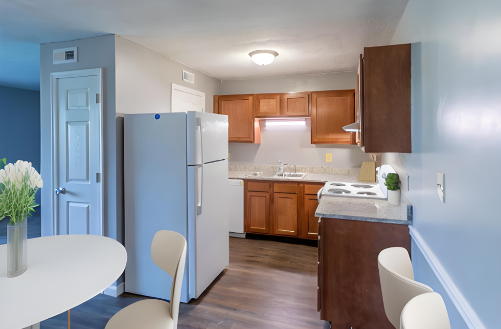 a kitchen with a refrigerator and a table and chairs at Crossings of Kenton, Erlanger, KY, 41018