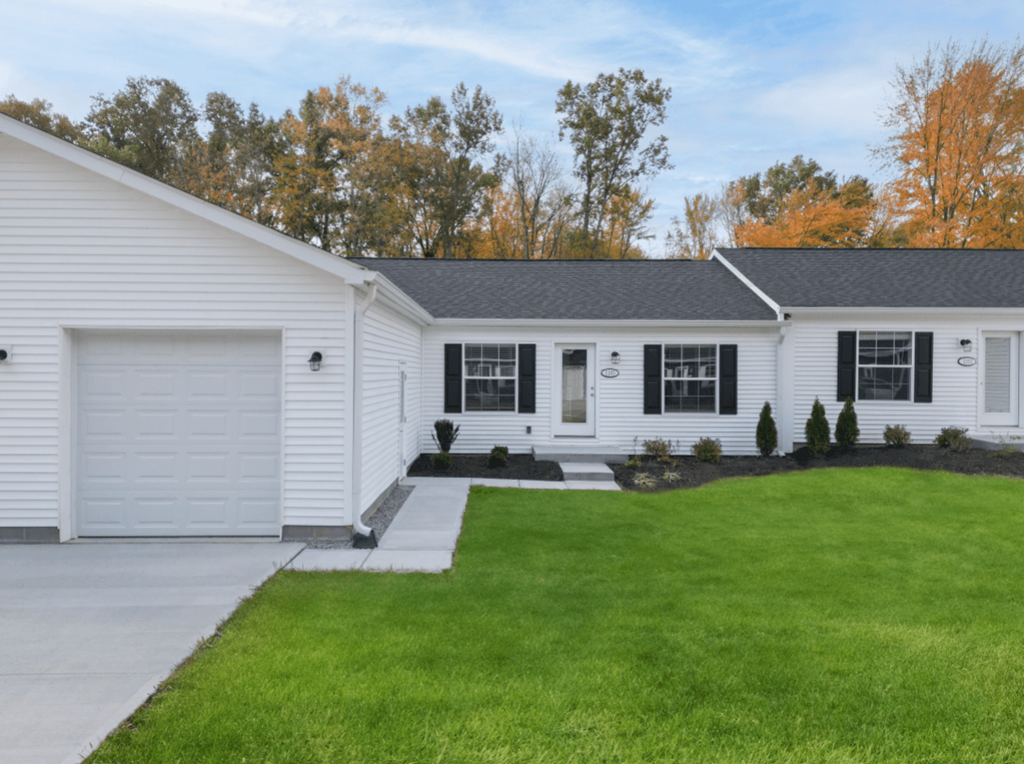 a white house with a lawn in front of it